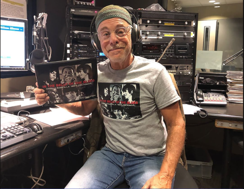 Terry in the studio holding a book.